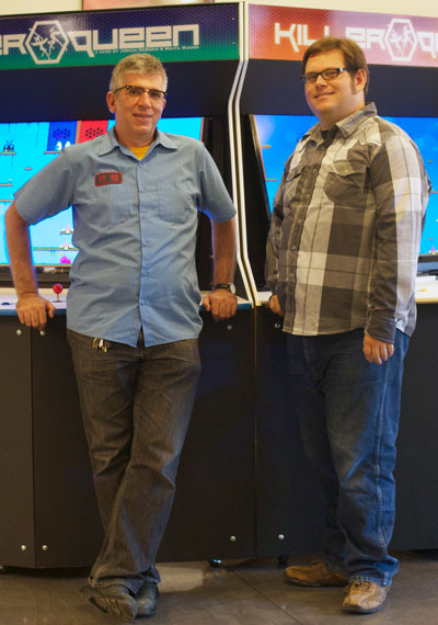 Killer Queen creators Nikita Mikros and Joshua DeBonis stand with their 10-player arcade cabinets. (Photo: Polygon)